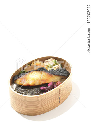 A bento lunch box with seaweed and grilled silver cod served in a bento box, photographed against a white background A bento lunch box with seaweed and grilled silver cod served in a bento box, photographed against a white background 132202062