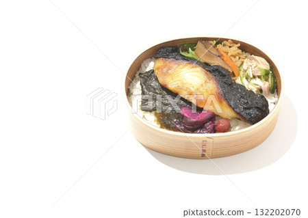 A bento lunch box with seaweed and grilled silver cod served in a bento box, photographed against a white background 132202070