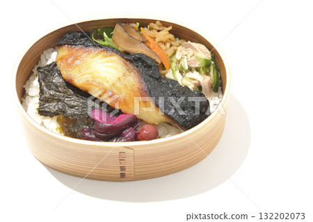 A bento lunch box with seaweed and grilled silver cod served in a bento box, photographed against a white background 132202073