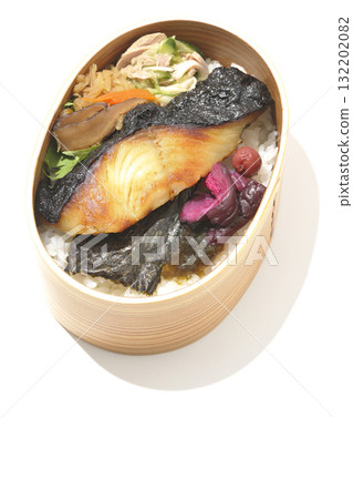 A bento lunch box with seaweed and grilled silver cod served in a bento box, photographed against a white background A bento lunch box with seaweed and grilled silver cod served in a bento box, photographed against a white background 132202082