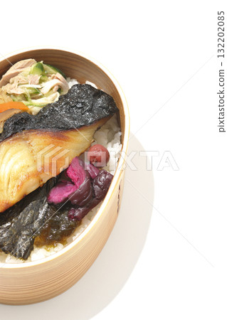 A bento lunch box with seaweed and grilled silver cod served in a bento box, photographed against a white background 132202085