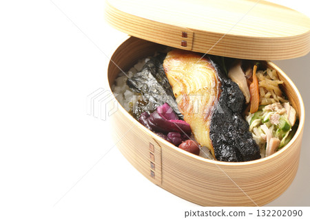 A bento lunch box with seaweed and grilled silver cod served in a bento box, photographed against a white background 132202090