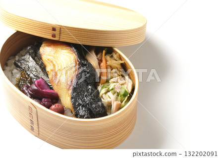 A bento lunch box with seaweed and grilled silver cod served in a bento box, photographed against a white background A bento lunch box with seaweed and grilled silver cod served in a bento box, photographed against a white background 132202091