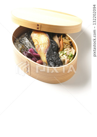 A bento lunch box with seaweed and grilled silver cod served in a bento box, photographed against a white background A bento lunch box with seaweed and grilled silver cod served in a bento box, photographed against a white background 132202094
