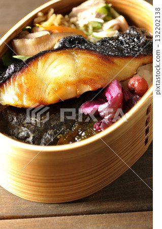 A bento lunch box with seaweed and grilled silver cod in a bento box. 132202138
