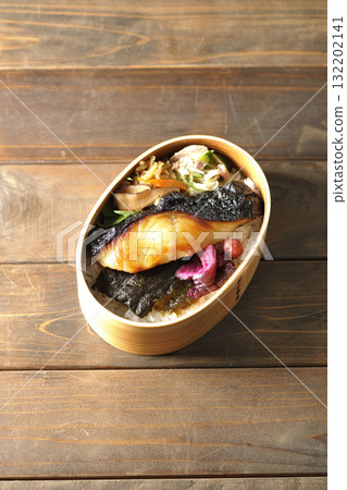 A bento lunch box with seaweed and grilled silver cod in a bento box. A bento lunch box with seaweed and grilled silver cod in a bento box. 132202141