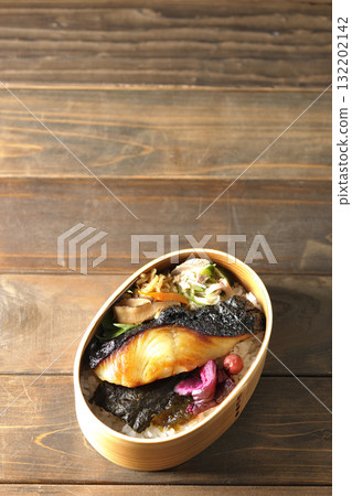 A bento lunch box with seaweed and grilled silver cod in a bento box. A bento lunch box with seaweed and grilled silver cod in a bento box. 132202142