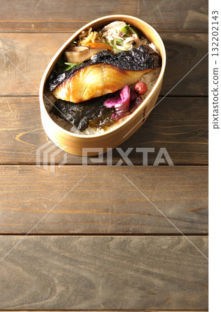 A bento lunch box with seaweed and grilled silver cod in a bento box. A bento lunch box with seaweed and grilled silver cod in a bento box. 132202143