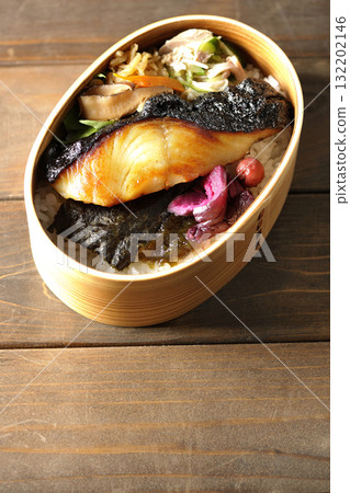 A bento lunch box with seaweed and grilled silver cod in a bento box. A bento lunch box with seaweed and grilled silver cod in a bento box. 132202146