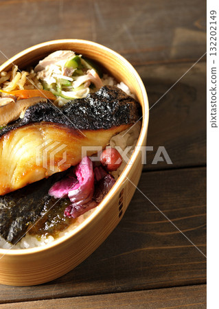 A bento lunch box with seaweed and grilled silver cod in a bento box. A bento lunch box with seaweed and grilled silver cod in a bento box. 132202149