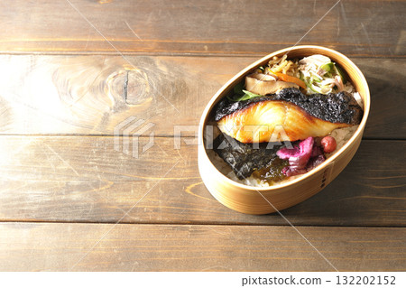 A bento lunch box with seaweed and grilled silver cod in a bento box. A bento lunch box with seaweed and grilled silver cod in a bento box. 132202152