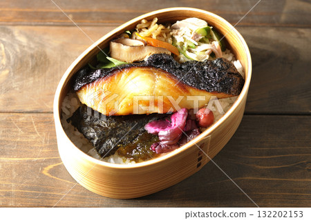 A bento lunch box with seaweed and grilled silver cod in a bento box. A bento lunch box with seaweed and grilled silver cod in a bento box. 132202153