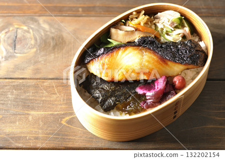 A bento lunch box with seaweed and grilled silver cod in a bento box. A bento lunch box with seaweed and grilled silver cod in a bento box. 132202154