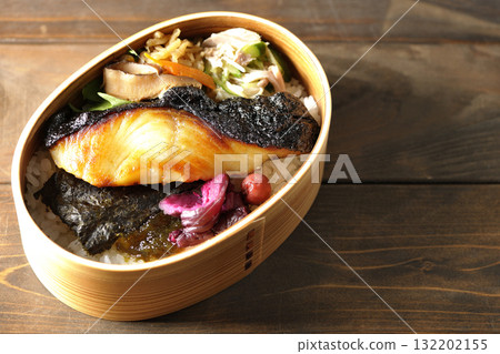 A bento lunch box with seaweed and grilled silver cod in a bento box. A bento lunch box with seaweed and grilled silver cod in a bento box. 132202155