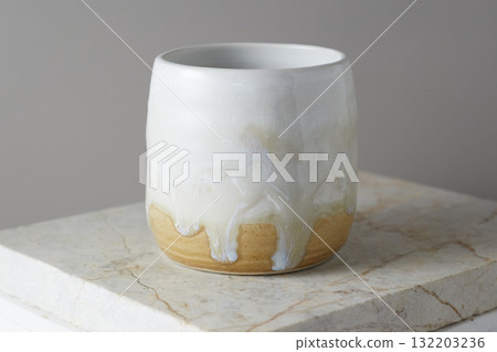 Close up ceramic cup on gray background Close up ceramic cup on gray background 132203236