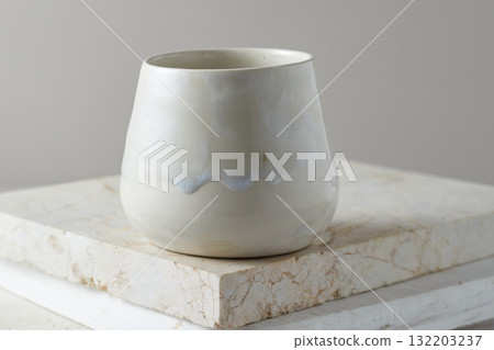 Close up ceramic cup on gray background Close up ceramic cup on gray background 132203237