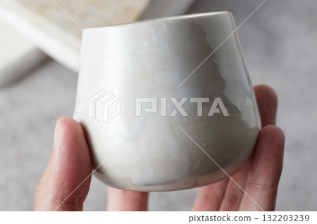 Close up ceramic cup on gray background 132203239