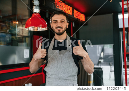 Thumbs up. Man is serving delicious street food 132203445