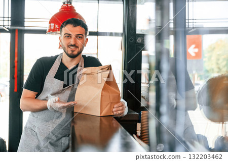 Man is serving delicious street food 132203462