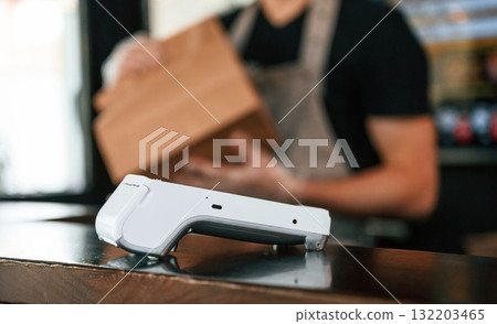 Payment by using terminal, order is ready. Man is serving delicious street food 132203465