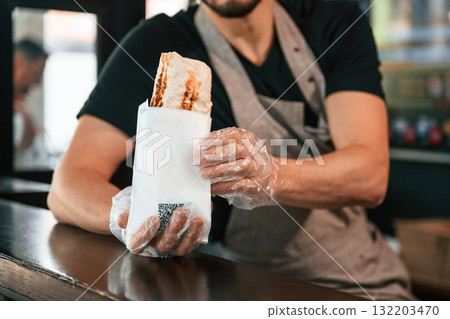 Shawarma man is indoors, conception of street food Shawarma man is indoors, conception of street food 132203470