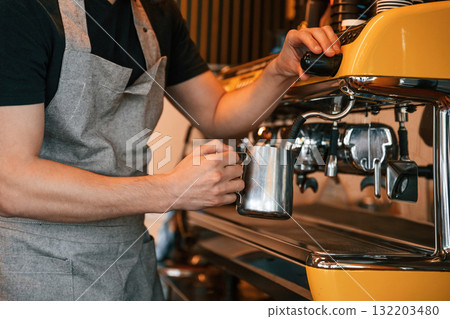 Pours a drink by using special machine. Man is serving delicious street food Pours a drink by using special machine. Man is serving delicious street food 132203480