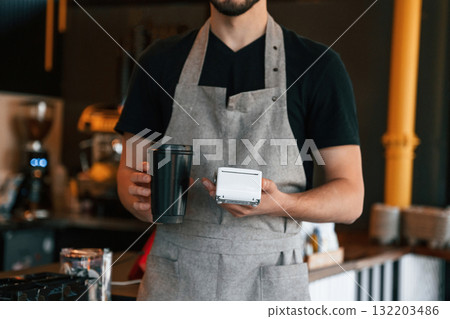 Drink and terminal for payment are ready. Man is serving delicious street food 132203486