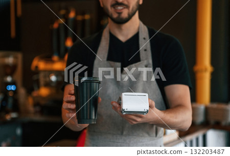 Drink and terminal for payment are ready. Man is serving delicious street food 132203487