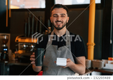 Drink and terminal for payment are ready. Man is serving delicious street food 132203489