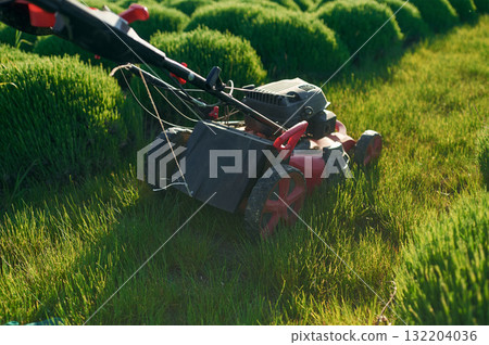 Lawn mower on the green field Lawn mower on the green field 132204036