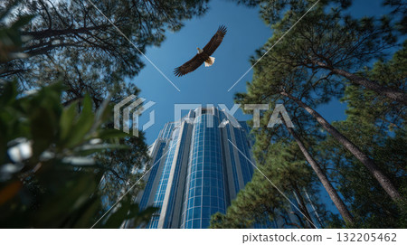 Minimal eagle soars above modern business building surrounded by natural environment with tall green trees under clear blue sky 132205462