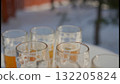 A partially filled beer glass enjoyed outdoors in winter A partially filled beer glass enjoyed outdoors in winter 132205824