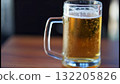 Close-up of a cold beer mug with foam and water droplets on a wooden table Close-up of a cold beer mug with foam and water droplets on a wooden table 132205826