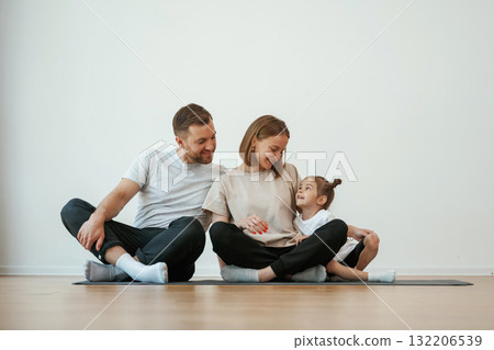 Family of mother, father and daughter are doing yoga at home 132206539