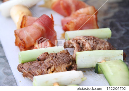 Stewed root, beef, and pork skewers 132206702