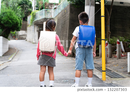 Elementary school student going to and from school, back view 132207303