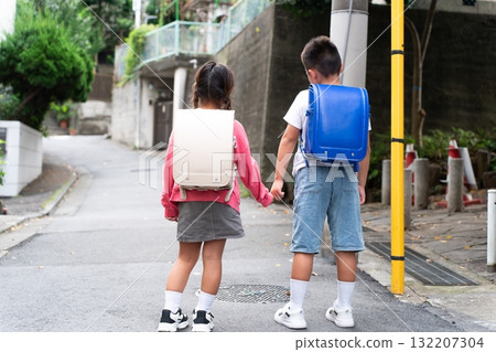 Elementary school student going to and from school, back view 132207304