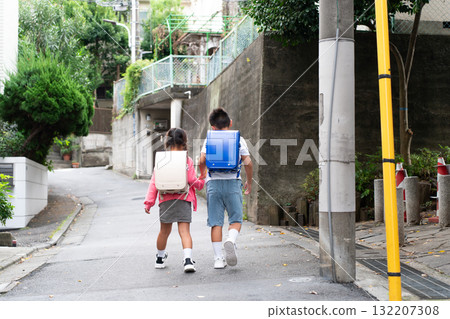 Elementary school student going to and from school, back view 132207308