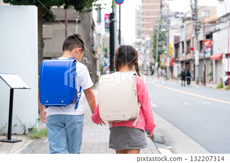 Elementary school student going to and from school, back view 132207314