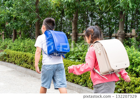 Elementary school student going to and from school, back view Elementary school student going to and from school, back view 132207329