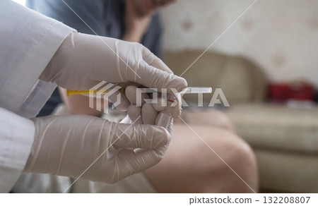 A man injects himself with adrenaline into his thigh during anaphylactic shock. First aid for allergies, emergency medical care for an allergic reaction. A man injects himself with adrenaline into his thigh during anaphylactic shock. First aid for allergies, emergency medical care for an allergic reaction. 132208807