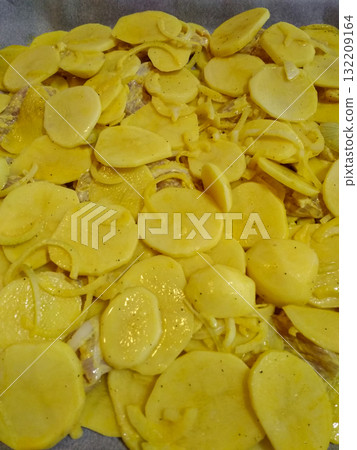 Raw potatoes and onions seasoned and ready for baking Raw potatoes and onions seasoned and ready for baking 132209164