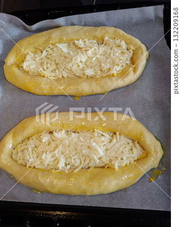 Adjarian khachapuri with sulguni cheese waiting to be baked in oven 132209168