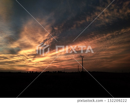 Stunning orange and blue sunset illuminating the countryside 132209222