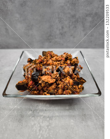 Eggplant and ground Turkey meat dish served on elegant glass plate Eggplant and ground Turkey meat dish served on elegant glass plate 132209533