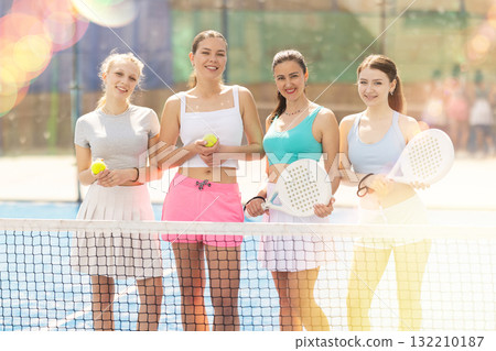 Women standing near the net on the court Women standing near the net on the court 132210187