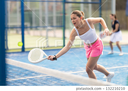 woman participates in a paddle tennis tournament 132210210