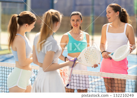 Women standing and talking on the court Women standing and talking on the court 132210249