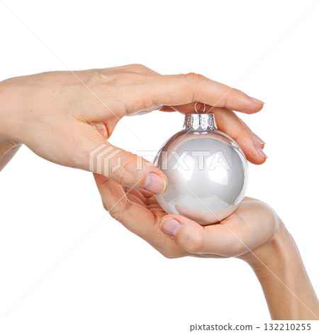 Two hands gently holding reflective silver christmas ornament, festive holiday detail isolated on transparent background Two hands gently holding reflective silver christmas ornament, festive holiday detail isolated on transparent background 132210255