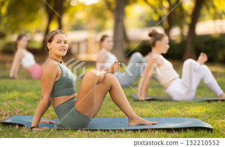 Various yoga poses performed by slender girls in the fresh air in summer garden Various yoga poses performed by slender girls in the fresh air in summer garden 132210552